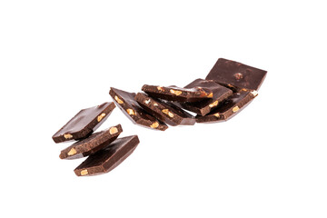 Poster - pieces of dark chocolate with nuts in a heap isolated on white background