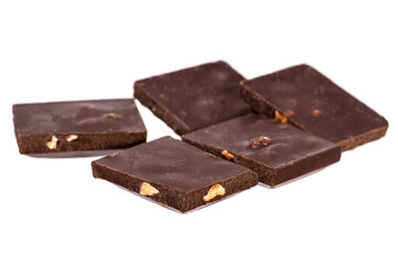 Poster - pieces of dark chocolate with nuts in a heap isolated on white background