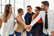 © Krakenimages.com - Group of business workers smiling happy standing with hands together at the office.