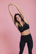 © kalinichenkod - Happy sportive Woman Over Pink Studio Background. Smiling girl after Fitness Workout. Healthy lifestyle concept