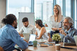 © Dragana Gordic - Shot of a group of businesspeople having a meeting in a modern office. Shot of a group of businesspeople sitting together in a meeting. Team of professionals discussing over new business project