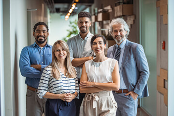 Smiling professional business coaches leaders mentors posing together with diverse office workers interns group, happy multicultural staff corporate employees people looking at camera, team portrait