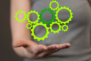 Poster - Mechanism green gears and cogs at work on black background. Industrial machinery. 3D illustration. 3D high quality rendering.