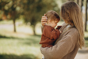 mother with baby daughter together in park