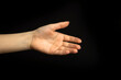 © FellowNeko - Young woman ready for handshake gesture on a black background. Business and professional teamwork concept photo