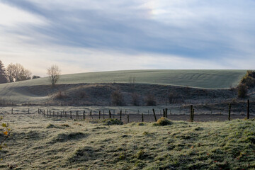 Morning frost covered green grass meadow on the mountain, Landscape view of hilly countryside in South Limburg (Zuid-Limburg) Gulpen is a village in the southern of the Dutch province, Netherlands.