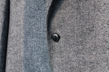 Wall Mural - Detail of grey wool blazer with button fragment.  Low DOF. Selective focus.