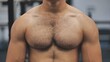 A man moves his strong and muscular chest