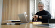 © muse studio - Lawyer gray makes a financial report in the company. The age manager works in the office. Workplace in coworking. Businessman online surf the internet.