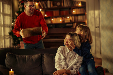 Wall Mural - Father and son gives Christmas gift to mother