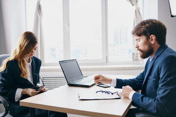 Wall Mural - managers sitting at a desk with a laptop communication finance technologies