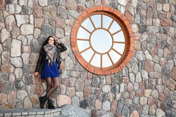 Wall Mural - young girl near the old stone wall