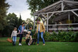 © Halfpoint - Happy young family with basket and blanket going to have picnic outdoors in restaurant area.
