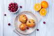 Homemade cranberry orange muffins on wooden plate, horizontal, top view