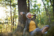 © Halfpoint - Portrait of senior woman relaxing and sitting with eyes closed outdoors in forest.