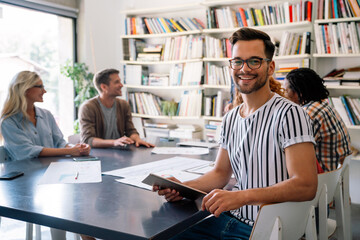 Group of successful business people, designers working together on startup project in office