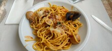 Egg Spaghetti With Seafood And Mussels On A White Plate
