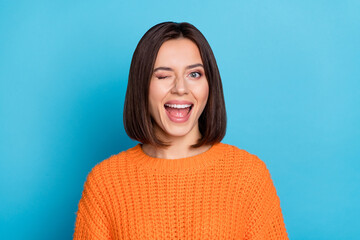 portrait of attractive flirty cheerful girl winking good mood isolated over vibrant blue color backg
