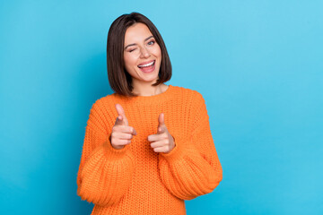 Canvas Print - Portrait of attractive flirty funny cheerful girl winking pointing forefingers at you isolated over vibrant blue color background