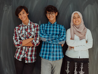 Wall Mural - A portrait of a group of Arab teenagers with crossed arms standing in front of a school board . The concept of modern and successful education