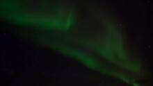 Beautiful Green Northern Lights -Aurora With The Stars Over A City At Night