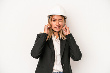 Poster - Young caucasian architect woman wearing a helmet isolated on white background covering ears with hands.