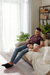 © DragonImages - Handsome young man stroking head of girlfriend who fell asleep with head on his laps