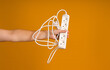 power strip with five sockets in hand on yellow background