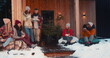© vadim_key - New Year holiday vacation. Group of happy friends drink tea talking at cozy Christmas tree house terrace slow motion.