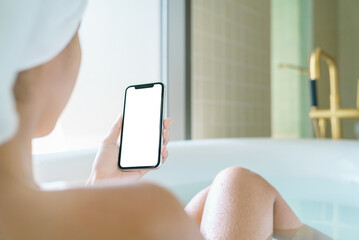 Aufkleber - phone blank screen display in woman hand, relax in bathtub with
