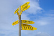 © sushaaa - Signpost with countries, blue sky in the background. Yellow boards showing the directions.