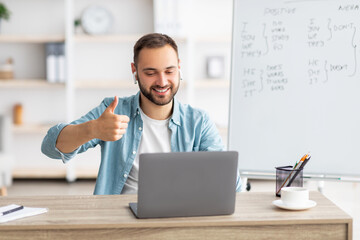 Poster - Happy male teacher giving English lesson on web using laptop, gesturing thumb up, recommending foreign languages school