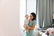 © Lisa Weatherbee - Female Doctor Carrying Daughter In Bedroom