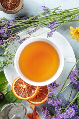 Poster - A cup of organic tea with dry fruit, flowers, and herbs, shot from above. Healthy hot drink