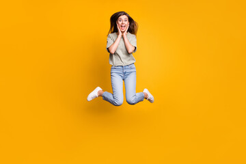 Poster - Full length body size view of lovely funny cheerful girl jumping having fun great news isolated over bright yellow color background