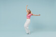 © ViDi Studio - Full body smiling young blonde woman 20s wearing casual pink t-shirt leaning back stand on toes fooling around isolated on plain pastel light blue background studio portrait. People lifestyle concept.