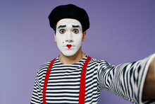 Close Up Surprised Young Mime Man With White Face Mask Wears Striped Shirt Beret Looking Camera Doing Selfie Shot Pov On Mobile Phone Isolated On Plain Pastel Light Violet Background Studio Portrait.