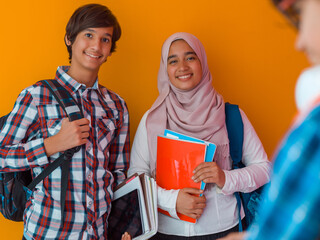 Wall Mural - A group of Arab teenagers, a student team walking forward into the future and back to school the concept of a yellow background. The concept of successful education for young people. Selective focus