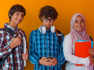 Wall Mural - A group of Arab teenagers, a student team walking forward into the future and back to school the concept of a yellow background. The concept of successful education for young people. Selective focus