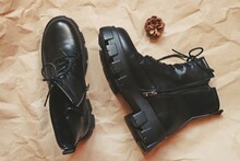 Trendy Footwear For Women. Stylish Ankle Boots On Brown Paper Background. Autumn And Winter Shoes Sale