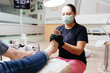 © fotofrol - Pedicure master cuts toenails of woman during pedicure procedure.