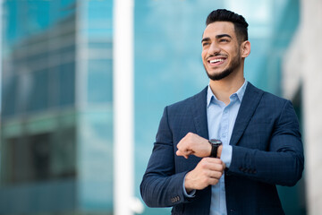 Successful arabic entrepreneur with watch on his wrist posing outdoors