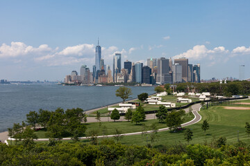 Wall Mural - Lower Manhattan Skyline view and Luxury Camping Tents on Governors Island in New York City during the Summer