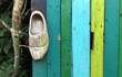 dutch wooden clog on colourful wall of painted wood
