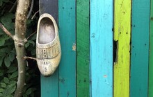 Dutch Wooden Clog On Colourful Wall Of Painted Wood