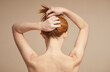 © Seventyfour - Minimal back view of young red haired woman with nude shoulders, copy space