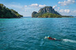 © Noppasinw - Tropical islands view with snorkeling driving tourist at ocean blue sea water and white sand beach, Krabi Thailand nature landscape