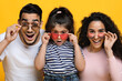 © Prostock-studio - Amazing Offer. Portrait Of Excited Arab Family Of Three Wearing Colorful Sunglasses