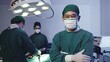 © sorapop - Surgeon doctor posing with arms crossed, Medical surgical doctor team performing surgery patient on operating room with electrocautery equipment for cardiovascular emergency surgery center in hospital