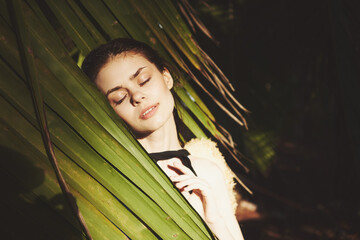 woman in swimwear palm leaf jungle island beach sun